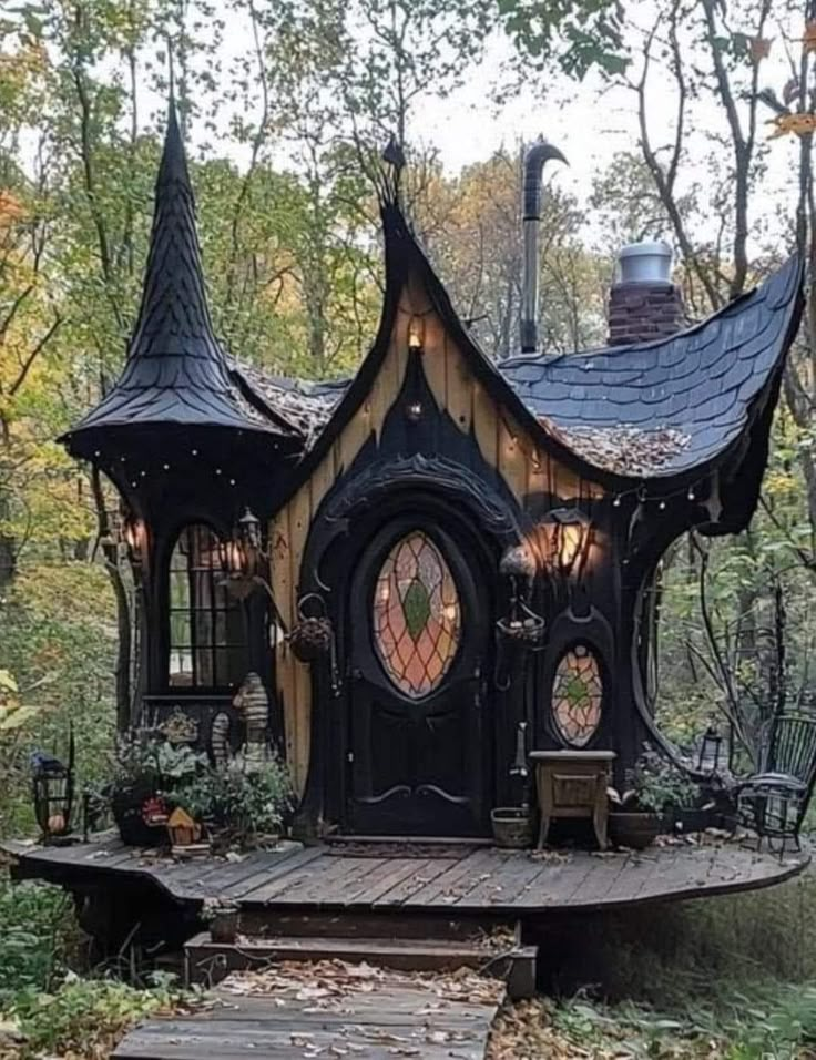 a black and brown fairy house in the woods