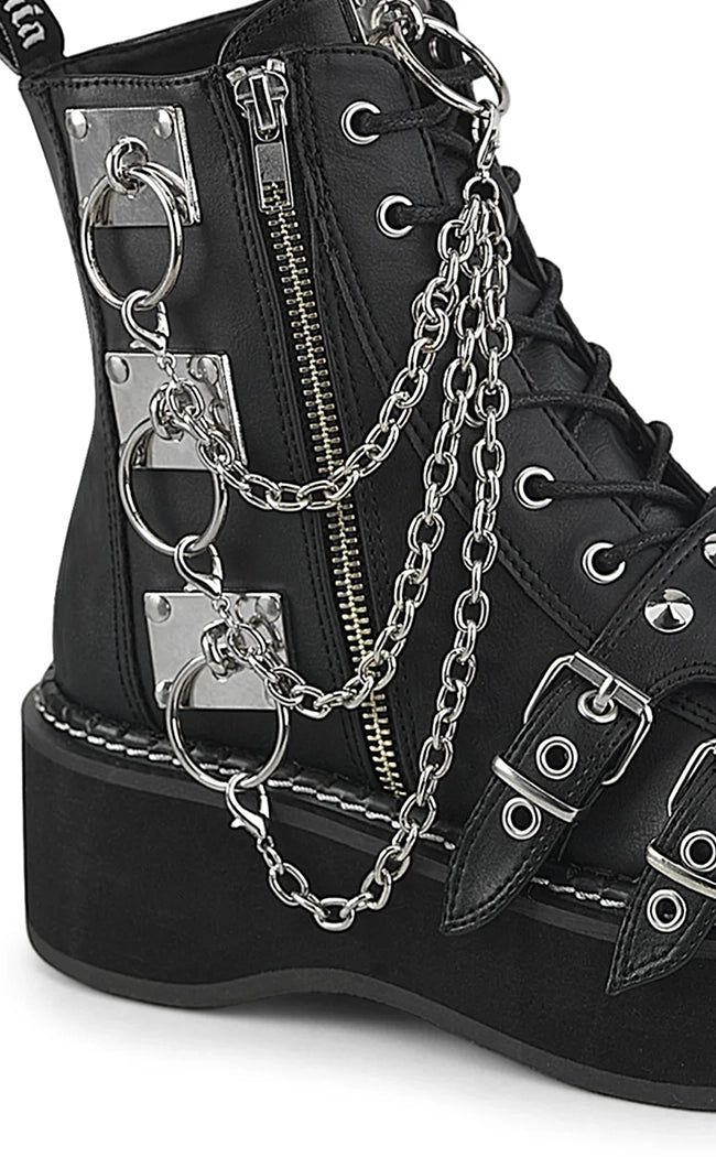 Break fashion barriers with the Demonia EMILY-57 boots! They're the ultimate mashup of style, comfort, and attitude, complete with plenty of chains to make some noise. Vegan Black PU leather/black canvas 2" (51mm) Platform Lace-Up Front Ankle Boot Removable chains Featuring 'Demonia' Branded Buckle Shield Straps Across the Vamp, O-Ring Knocker & Hanging Chain on the Outer Side, O-Ring Knocker on the Tongue Side zip U.S women's sizing-refer to size chart for more info