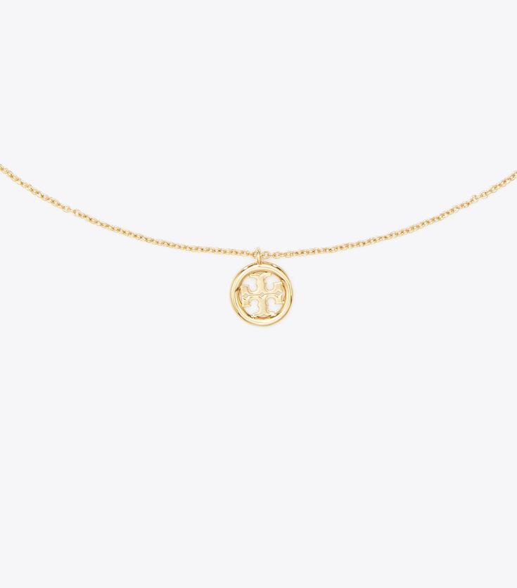 Miller Pendant Necklace: Women's Designer Necklaces | Tory Burch Classic Yellow Gold Necklace With Logo Charm, Yellow Gold Brass Jewelry With Logo Charm, Gold Medallion Necklace With Logo Charm, Yellow Gold Round Pendant Charm Necklaces For Layering, Yellow Gold Charm Necklace With Round Pendant For Layering, Yellow Gold Medallion Necklace With Logo Charm, Gold Pendant Chain Necklace With Logo Charm, Elegant Yellow Gold Charm Necklace With Logo, Gold Pendant Necklace With Logo Charm