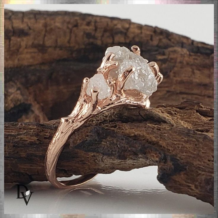 a close up of a ring on top of a piece of wood