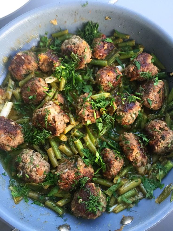 meatballs and green beans in a blue bowl