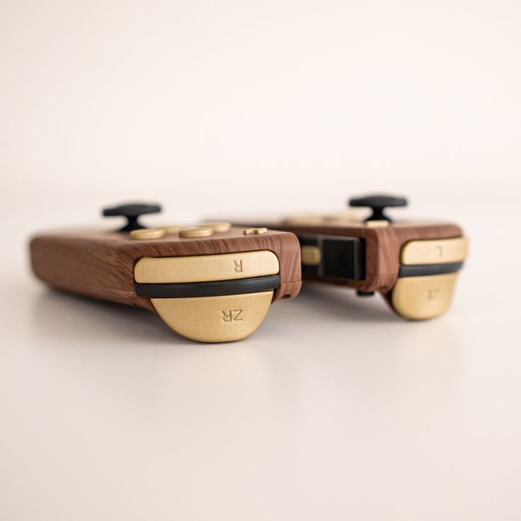 two wooden video game controllers sitting side by side