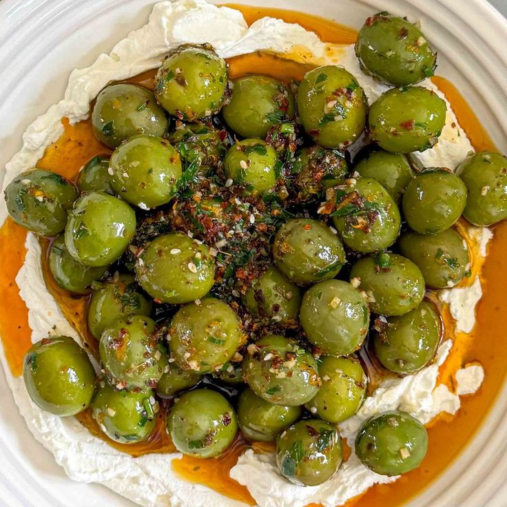 a white plate topped with brussel sprouts covered in cheese and sauce