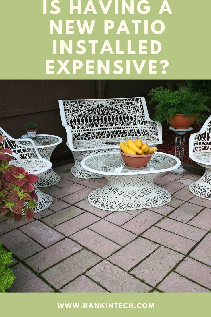 white wicker patio furniture with text overlay that reads is having a new patio installed expensive?