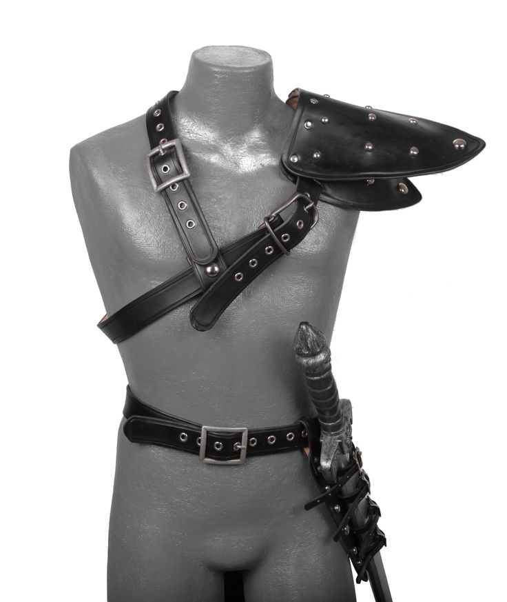 a male mannequin wearing a black leather harness with spikes and chains on it