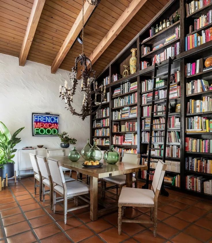 the dining room table is surrounded by bookshelves