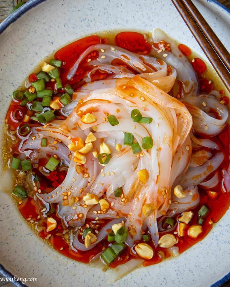 a white plate topped with food and chopsticks