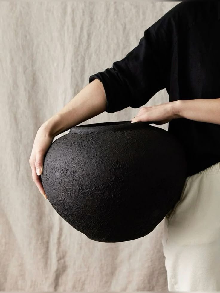 a person holding a large black object in their hands