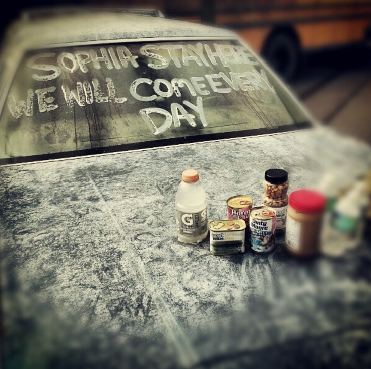 an old car with writing on it and some condiments sitting on the hood