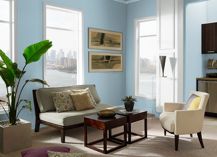 a living room with blue walls and furniture