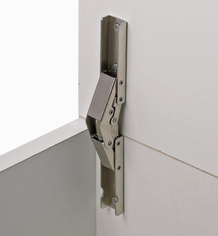 a metal door hinge on the side of a white wall with no glass in it