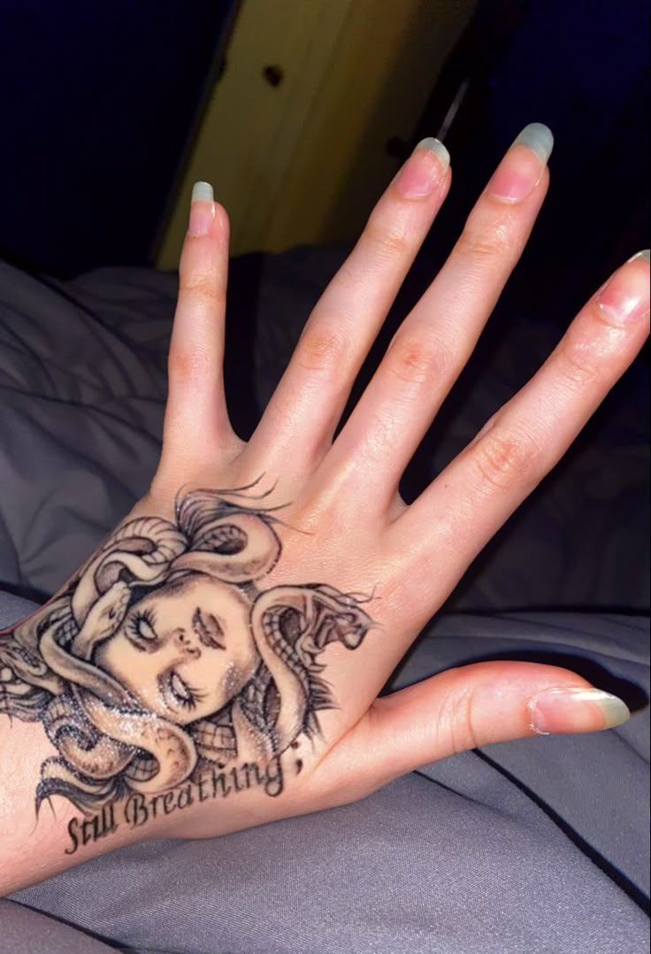 a woman's hand with a tattoo on it