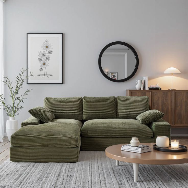 a living room filled with furniture and a round mirror on the wall over a coffee table