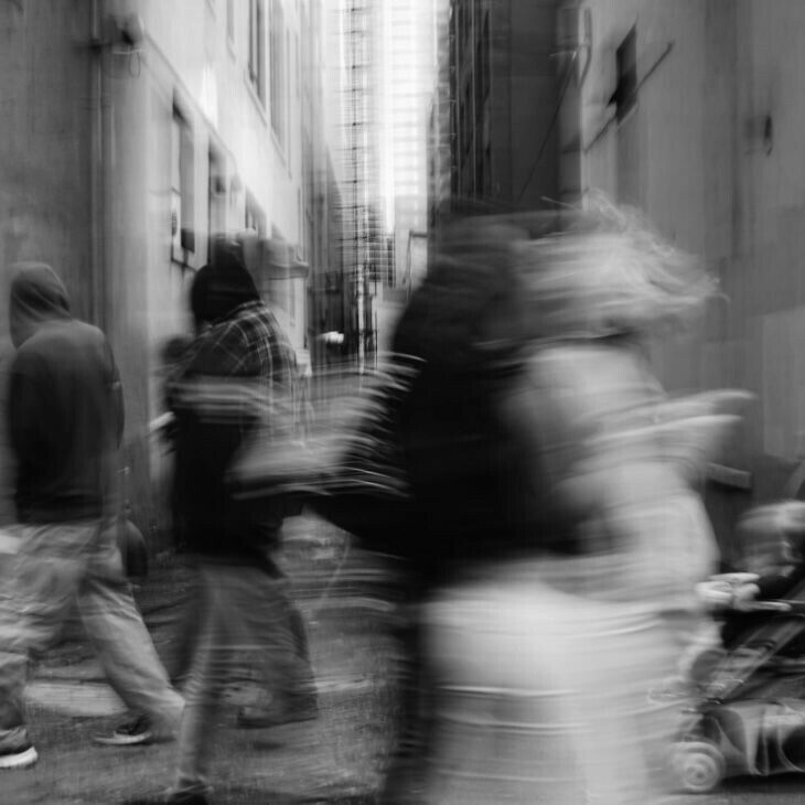 blurry photograph of people walking down the street