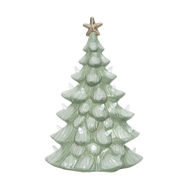 a green glass christmas tree with lights on it's sides and a star hanging from the top