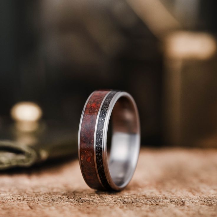 The DinoStar wedding band: a tribute to the ancient and the celestial, this titanium ring features inlays of agatized dinosaur bone and meteorite dust. With its sleek and modern design, The DinoStar is the perfect choice for the groom who values history, discovery, and the natural world. The DinoStar Meteorite & Dinosaur Bone Wedding Band Features: Lightweight, durable, hypoallergenic titanium ring Authentic agatized dinosaur bone fossil from Utah Munionalusta Meteorite Fit: Comfort Fit Finish: Meteorite Wedding Rings, Dinosaur Bone Ring, Rustic Wedding Bands, Bone Ring, Engraving Fonts, 10k Gold Ring, Meteorite Ring, Titanium Wedding Band, Dinosaur Bones