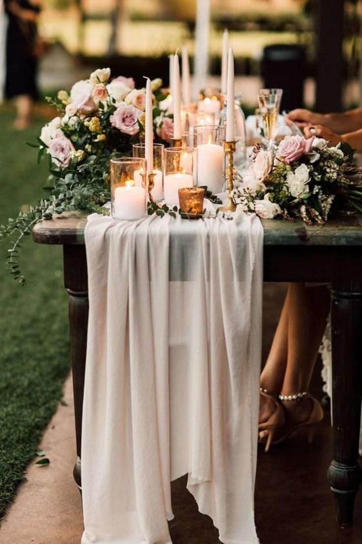 a table with candles and flowers on it