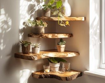 three wooden shelves with potted plants on them in the corner of a room next to a window