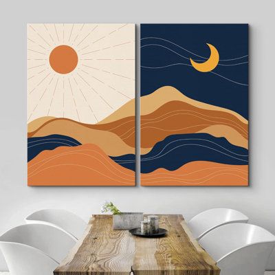 two paintings on the wall above a dining room table