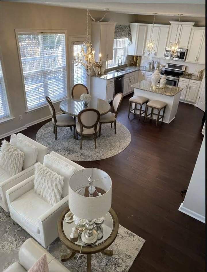 an aerial view of a living room and dining room in a home with hardwood floors