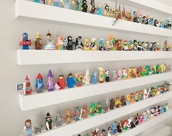 there are many toy figurines on the shelves in this room, all lined up