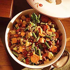 a white bowl filled with food on top of a wooden table