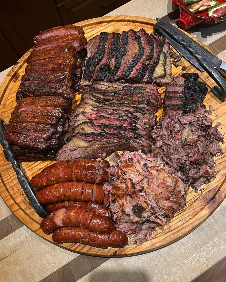 a plate full of meats and sausages on a table