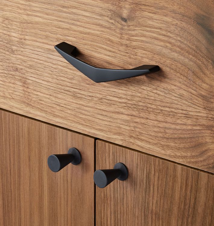 a wooden cabinet with black handles and knobs