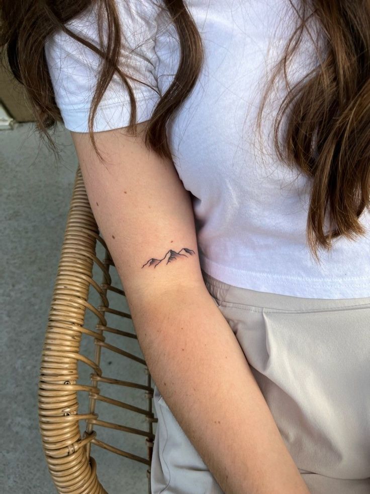 a woman with a small tattoo on her arm