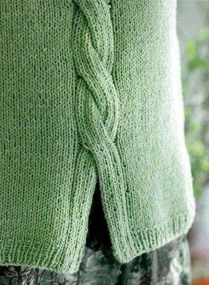 the back of a green sweater with a knoted design on it's side