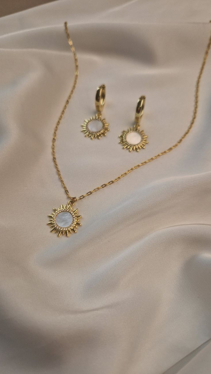 Elevate your wedding day style with our exquisite boho jewelry set. Featuring a stunning celestial pendant chain necklace and elegant gold plated sun earrings, this collection is designed for the modern bride who loves bohemian charm. Each piece is crafted with meticulous attention to detail, blending celestial motifs with timeless elegance to create jewelry that is both unique and breathtaking. MATERIAL - 18 K gold plated brass, natural mother of pearl SIZE - standard size of the necklace - 45 Celestial Metal Jewelry, Handmade Celestial Gold Plated Jewelry, Bohemian Gold Plated Jewelry For Wedding, Bohemian Gold Jewelry Sets For Wedding, Ethereal Gold Pendant Jewelry, Celestial Style Dangle Jewelry For Wedding, Elegant Brass Jewelry With Moon Charm, Handmade Celestial Gold Jewelry, Bohemian Clavicle Chain Jewelry