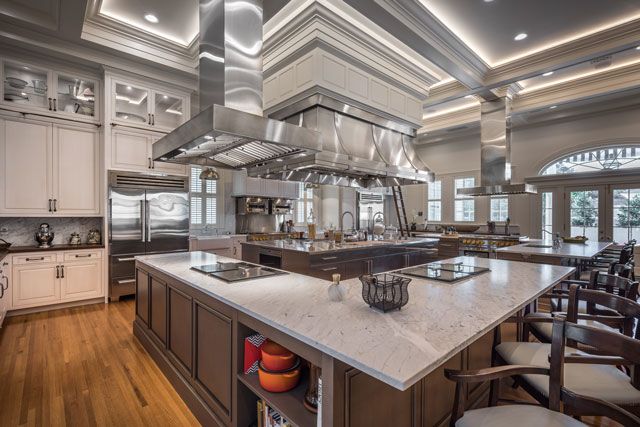 a large kitchen with an island in the middle and lots of counter space on one side