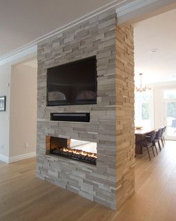 a fireplace with a flat screen tv mounted on it's side in a living room