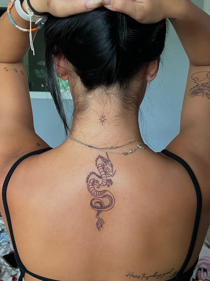 a woman with a dragon tattoo on her back