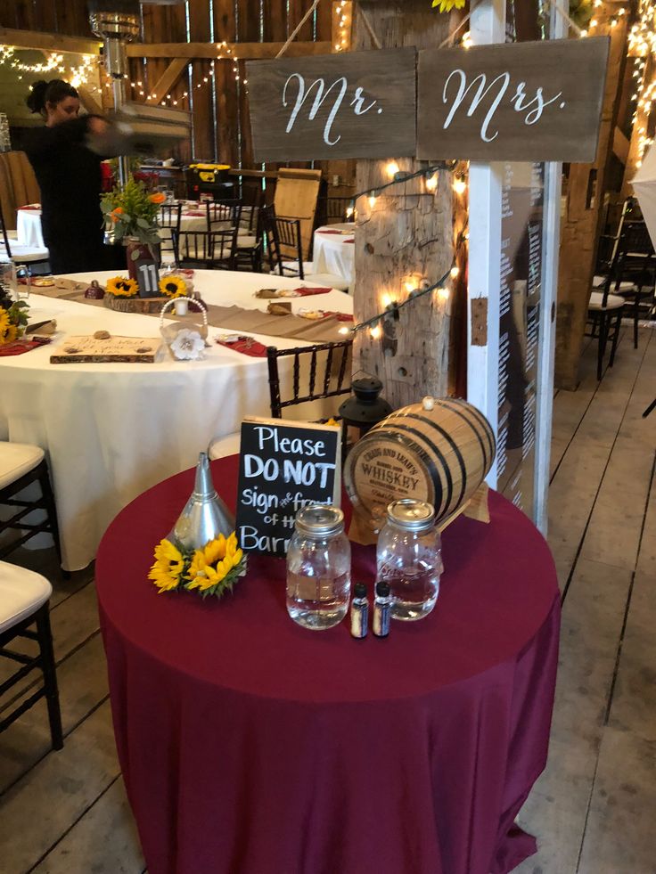 the table is set up with wine glasses and signs for mr and mrs on it