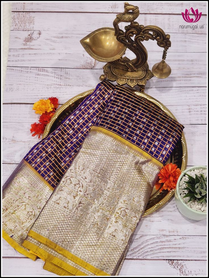 Venkatagiri silk/pattu Saree is woven in Venkatagiri of Nellor district in the Indian State of Andra pradesh. It was registered as one of the geographical indications from Andhra Pradesh. Venkatagiri sarees are known for their fine weaving,fine quality and workmanship. This beautiful rich silk saree in deep violet with small checks in copper zari and buttas in silk zari all over the body. The contrast yellow pallu and border with silver zari compliments the saree. The yellow blouse piece matches Purple Handloom Pre-draped Saree For Puja, Purple Handloom Pre-draped Saree For Diwali, Traditional Purple Pre-draped Saree For Navratri, Traditional Purple Pre-draped Saree For Puja, Purple Pre-draped Saree For Puja, Traditional Purple Paithani Silk Pre-draped Saree, Purple Self-design Pre-draped Saree For Puja, Purple Pre-draped Saree With Cutdana For Traditional Ceremonies, Purple Paithani Silk Traditional Drape Wear