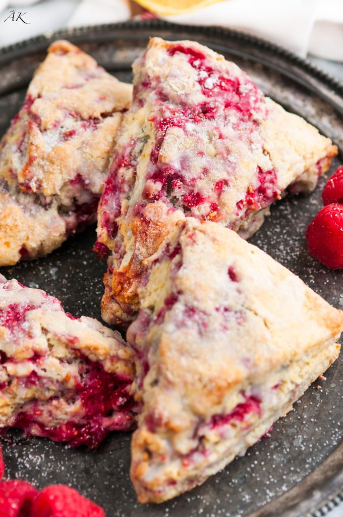 raspberry scones on a plate with fresh raspberries