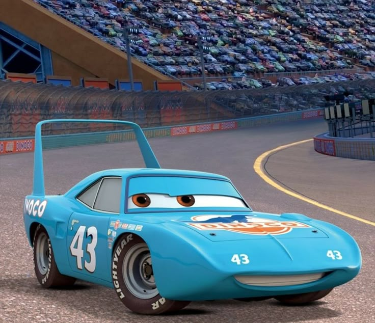 a blue race car driving down a track