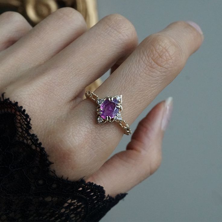 Introducing our captivating Cairo Starry Night Purple Sapphire Ring, a mesmerizing blend of timeless elegance and cultural inspiration. This exquisite ring features a captivating oval bi-color purple sapphire center stone. Crafted with meticulous attention to detail, the band of this ring showcases intricate stars, reminiscent of the stunning architectural motifs found in the bustling streets of Cairo. The oval purple sapphire, set in a secure and stylish double claw prong setting, radiates a de Luxury Purple Diamond Promise Ring, Unique Amythest Engagement Rings, Amythest And Diamond Rings, Luxury Purple Cluster Ring For Engagement, Luxury Heirloom Amethyst Ring With Diamonds, Luxury Amethyst Wedding Ring, Luxury Heirloom Amethyst Promise Ring, Amythest Rings Engagement, Amythest Engagement Rings Crystal