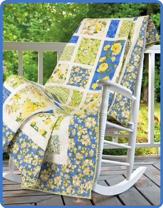 a rocking chair covered with a quilt on a porch