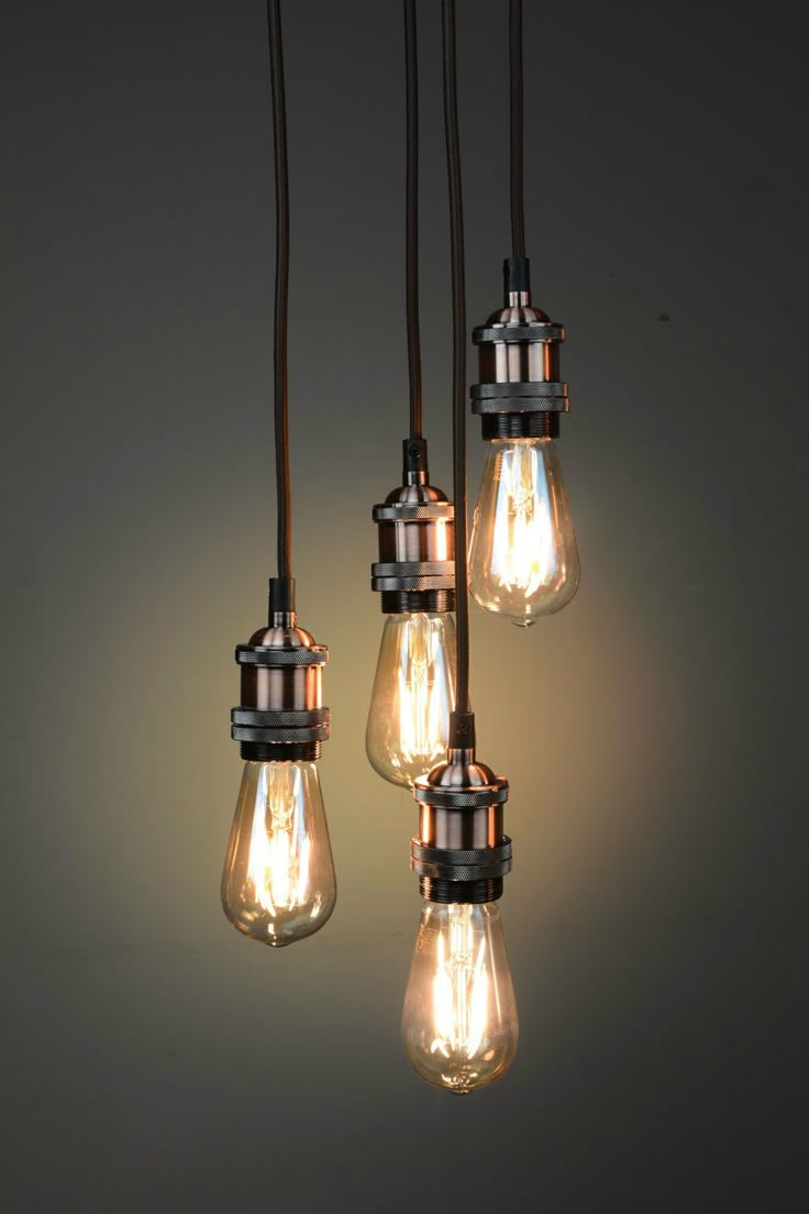 five light bulbs hanging from a chandelier in an industrial - style lighting fixture