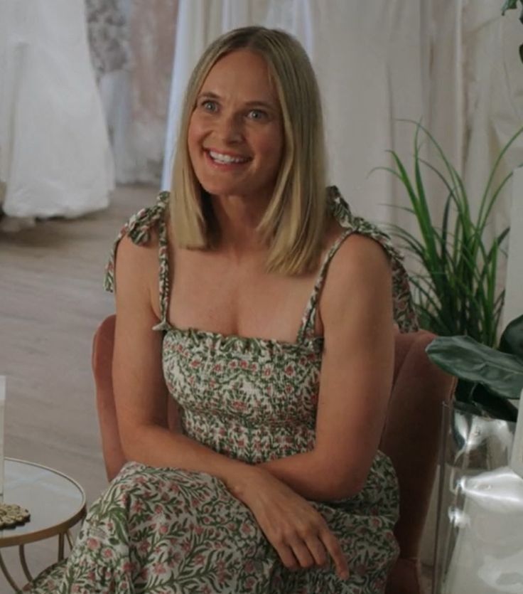 a woman sitting on a chair in front of a cake