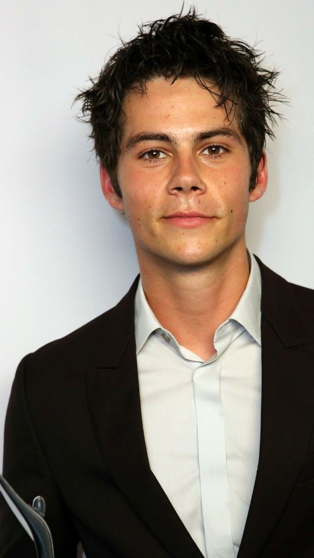 a young man in a black suit and white shirt