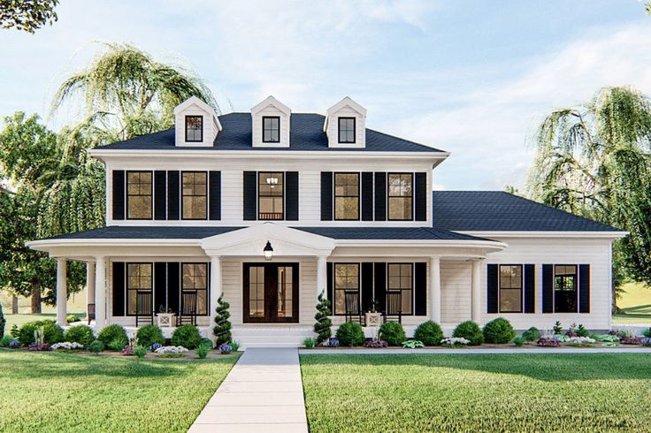 a large white house with black shutters on the front and side windows is shown