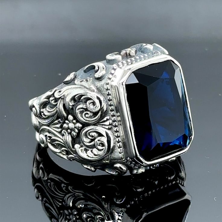 Elevate your style with this exquisite silver sapphire stone ring, handcrafted with intricate Ottoman-inspired engravings. Featuring a striking blue sapphire gemstone, this 925k silver ring exudes timeless elegance. Meticulously crafted by skilled artisans, each ring is a unique work of art that will add a touch of sophistication to any outfit. With its exceptional craftsmanship and eye-catching design, this ring is a true statement piece that will turn heads wherever you go. Embrace the rich cultural heritage and indulge in the luxury of this stunning sapphire ring. • Gender : Male / Female• Material : 925K Sterling Silver• Total weight : 19 Grams• Gemstone : Sapphire Stone Stone Ring Men, Emerald Stone Rings, Mystic Topaz Ring, Saphir Ring, Ottoman Styling, Blue Sapphire Gemstone, Engraved Wedding, Blue Sapphire Ring, Ring Men