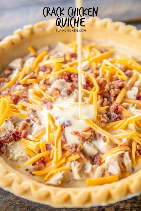 an uncooked pie crust with cheese being drizzled over it and topped with ground beef