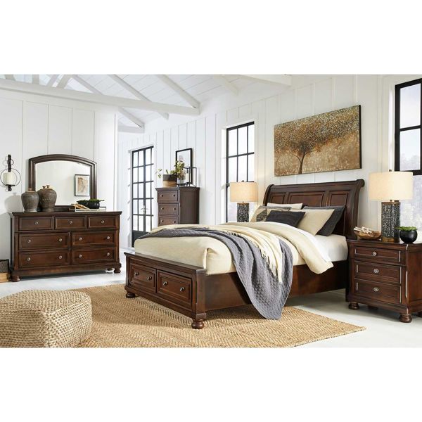 a bedroom scene with focus on the bed and dresser