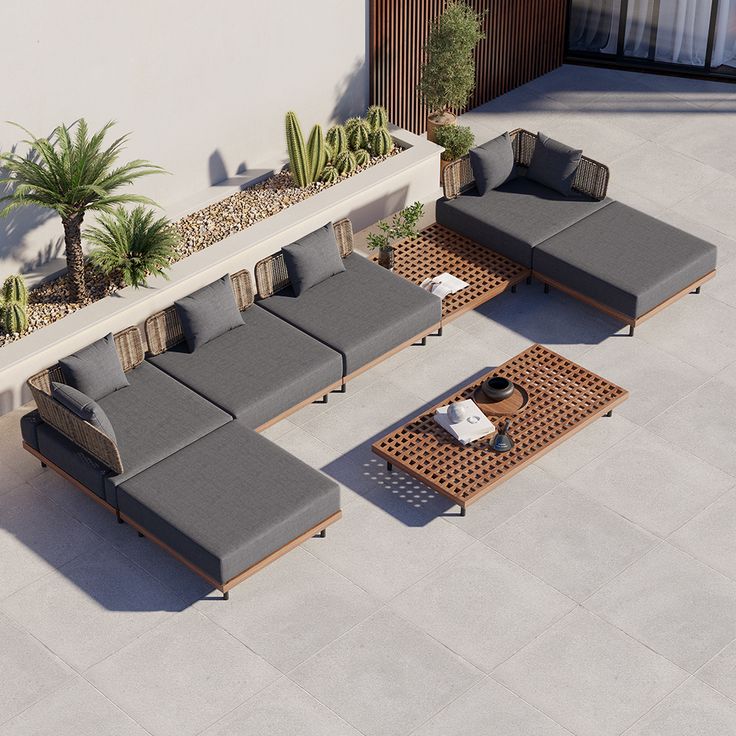 an outdoor seating area with couches and potted plants