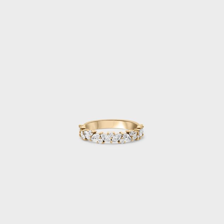 a gold ring with five small diamonds