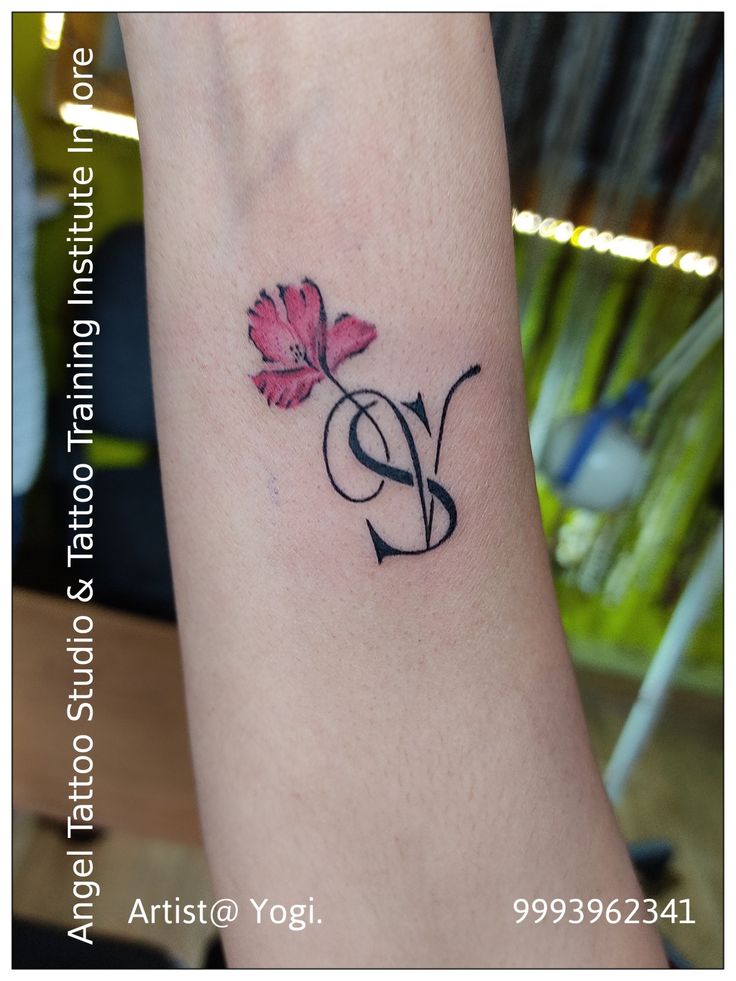 a small tattoo on the arm of a woman with a flower in it's center